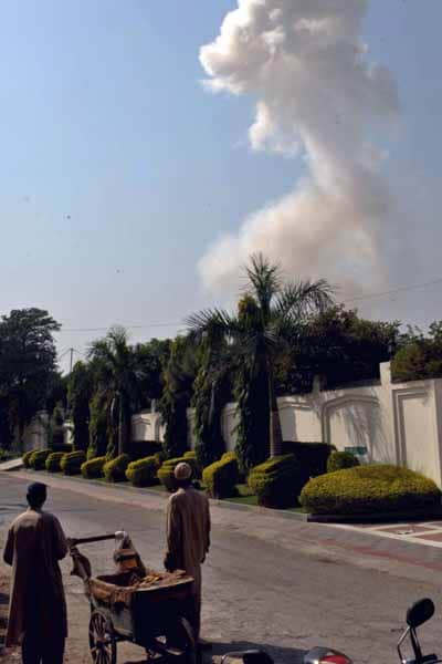 <p>Smoke billows from the site of the explosion. Reports add that the restaurant targeted in the attack belonged to the son of a senior leader of the Awami National Party, which is in power in NWFP and is part of the ruling coalition at the Centre. (AFP Photo)</p>